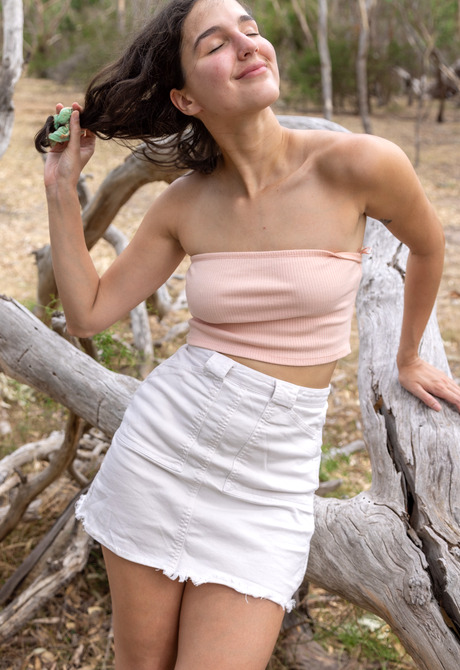 Cute brunette Wendy getting naked and pissing in nature