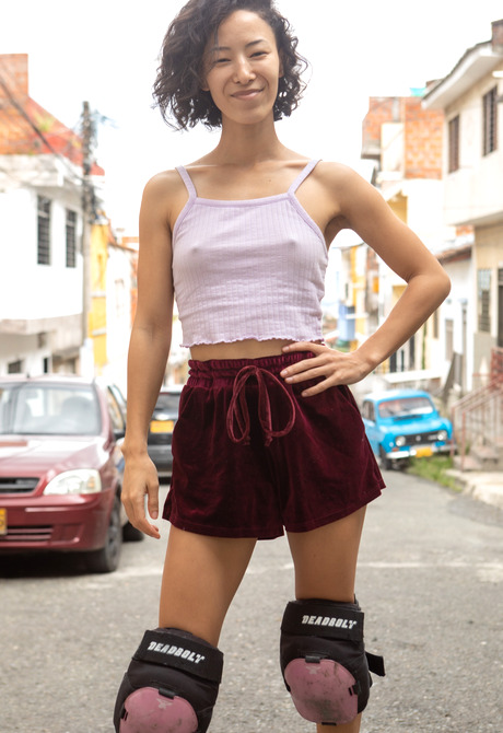 Skinny athletic asian Kira R roller skating and spreading hairy pussy