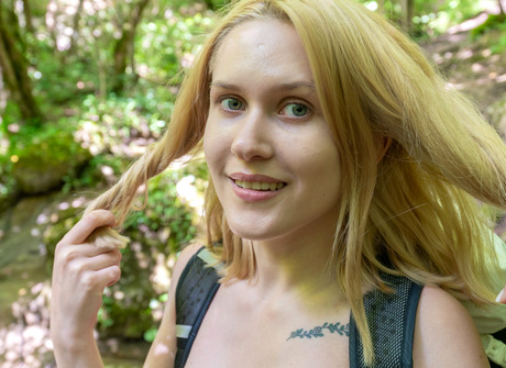 Cute blonde teen Una teasing naked outdoors in nature