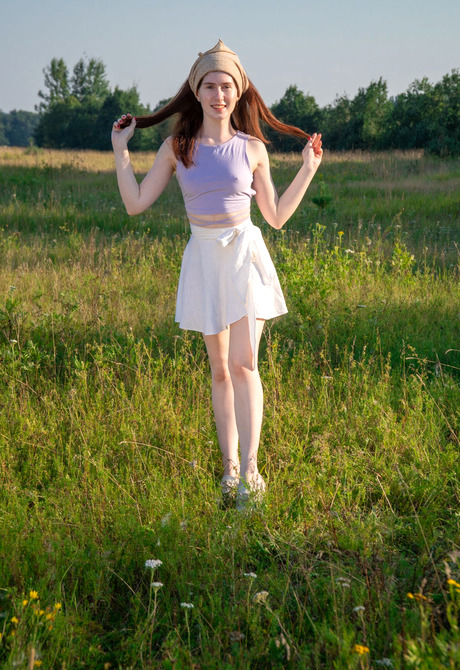 Petite redhead amateur Pearl getting naked in the forest