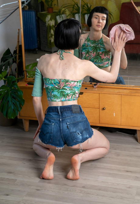 Slender amateur girl Delfine teasing and peeling off jean shorts - 1 of 16